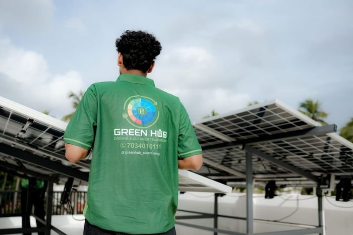 Green Hub solar technician inspecting high-efficiency solar panels