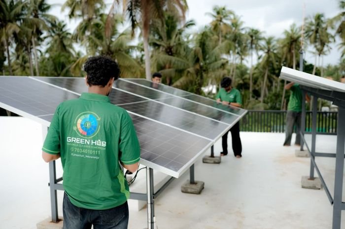 Green Hub technicians assembling elevated solar structure and mounting solar panels
